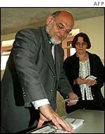 Communist leader Robert Hue casts his vote