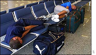 Two unidentified travellers sleep in the airport terminal of Palma Majorca