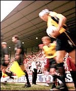 Players and officials take the field