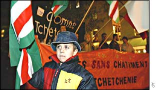 A Chechen boy holds the National flag at a demonstration in Paris on Thursday 14 November