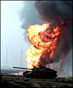 Tank in front of flaming oil wells in 1991
