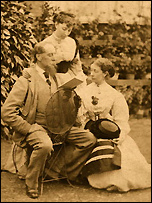 Charles Dickens the family man reading to one of his daughters and her companion.